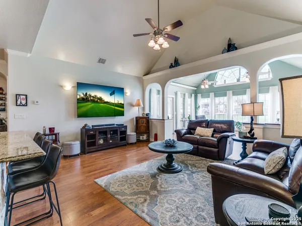 a living room with furniture a large window and a flat screen tv