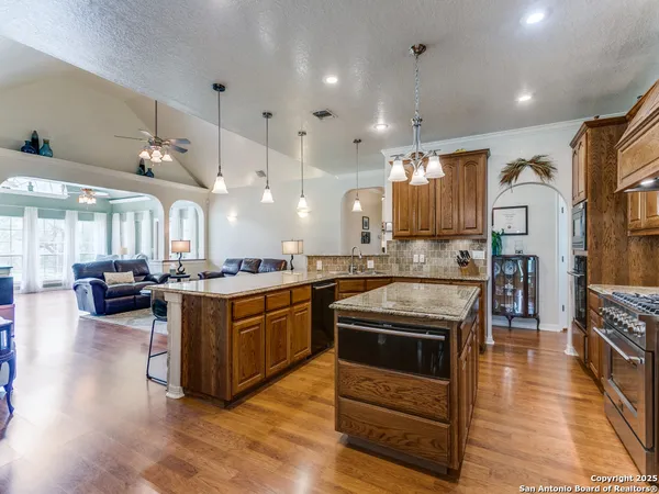 a kitchen with stainless steel appliances granite countertop a stove and a refrigerator