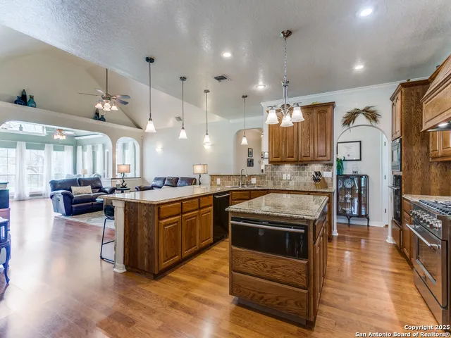 a kitchen with stainless steel appliances granite countertop a stove and a refrigerator