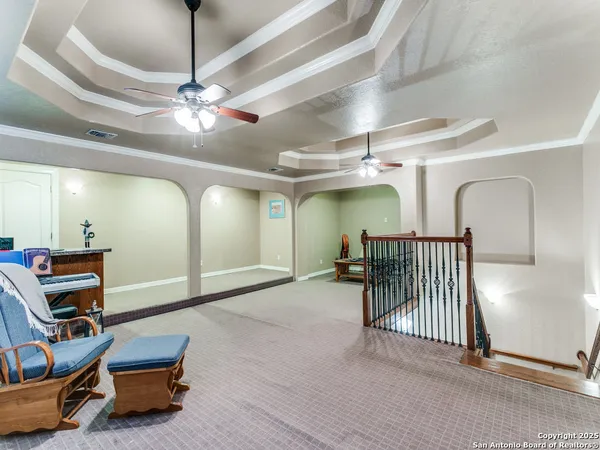 a room with furniture and a ceiling fan