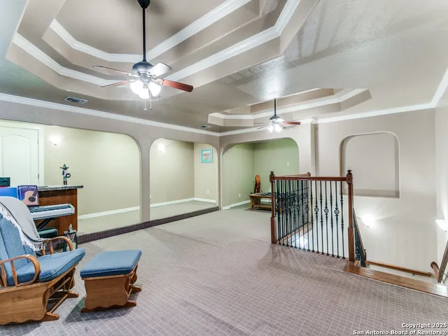 a room with furniture and a ceiling fan
