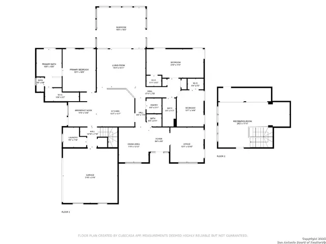 an aerial view of a house with outdoor space and trees all around