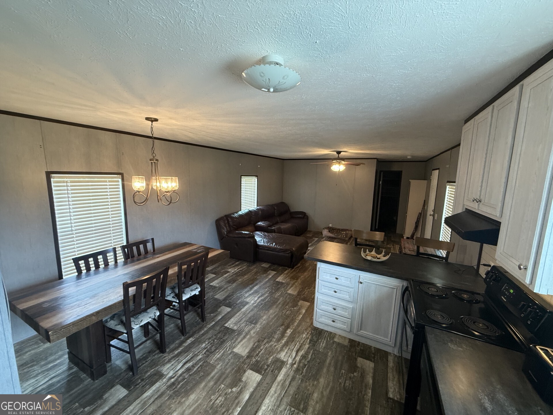 50 Harvest Road Coleman, GA 39836 - Photo 27 of 37 a living room with furniture a mirror and a flat screen tv