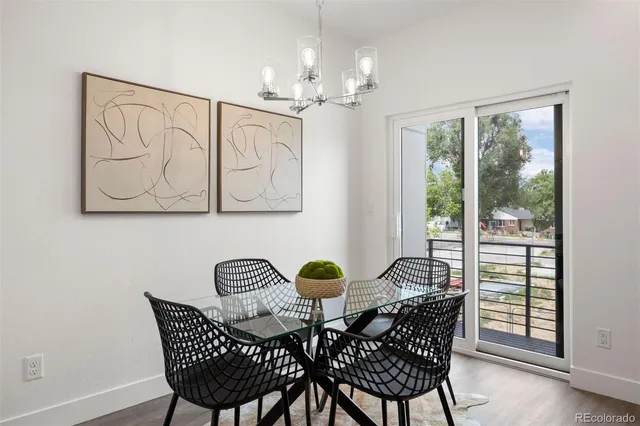 a view of a dining room with furniture and chandelier