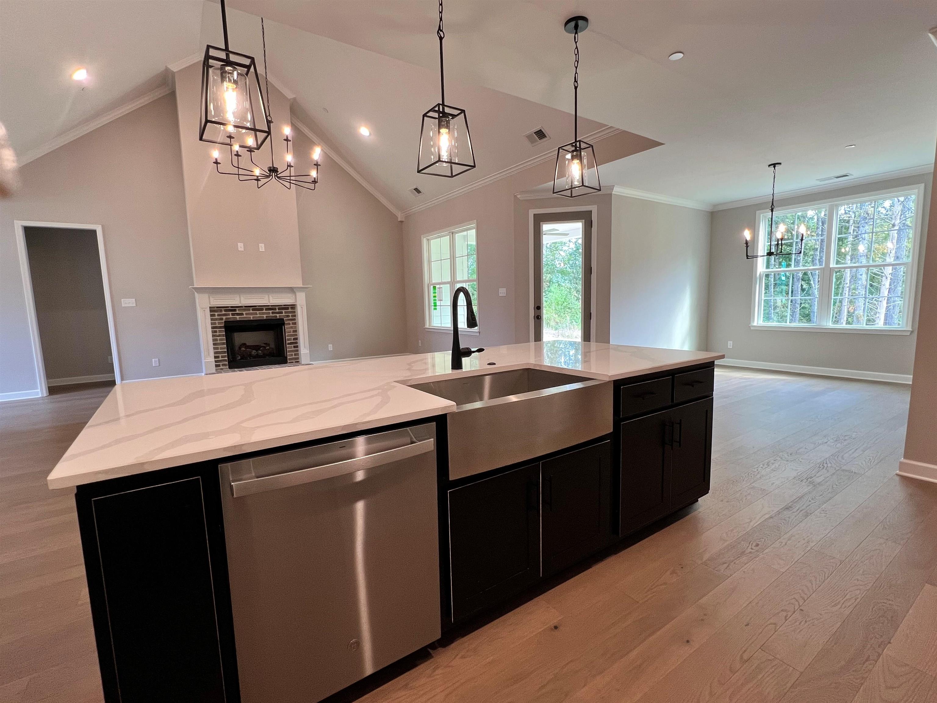 220 Drake Drive Collierville, TN 38017 - Photo 4 of 30 a kitchen with a center island wooden floor and a chandelier