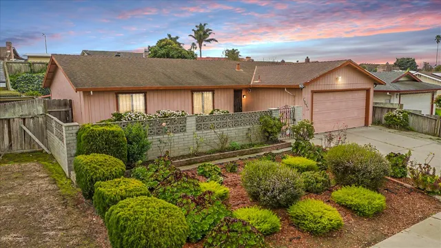 a view of a hallway with wooden floor and a front door
