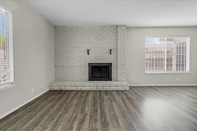 a view of a dining room with furniture a rug and wooden floor