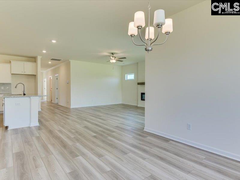 628 Old Charleston Road Pelion, SC 29123 - Photo 14 of 36 a view of a room with wooden floor and chandelier