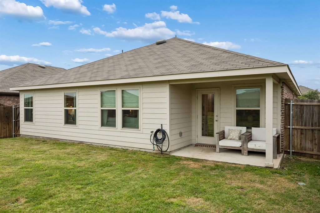 1107 Ringgold Road Forney, TX 75126 - Photo 8 of 27 Rear exterior featuring a covered concrete patio, multiple windows, a glass-paneled door, and horizontal siding