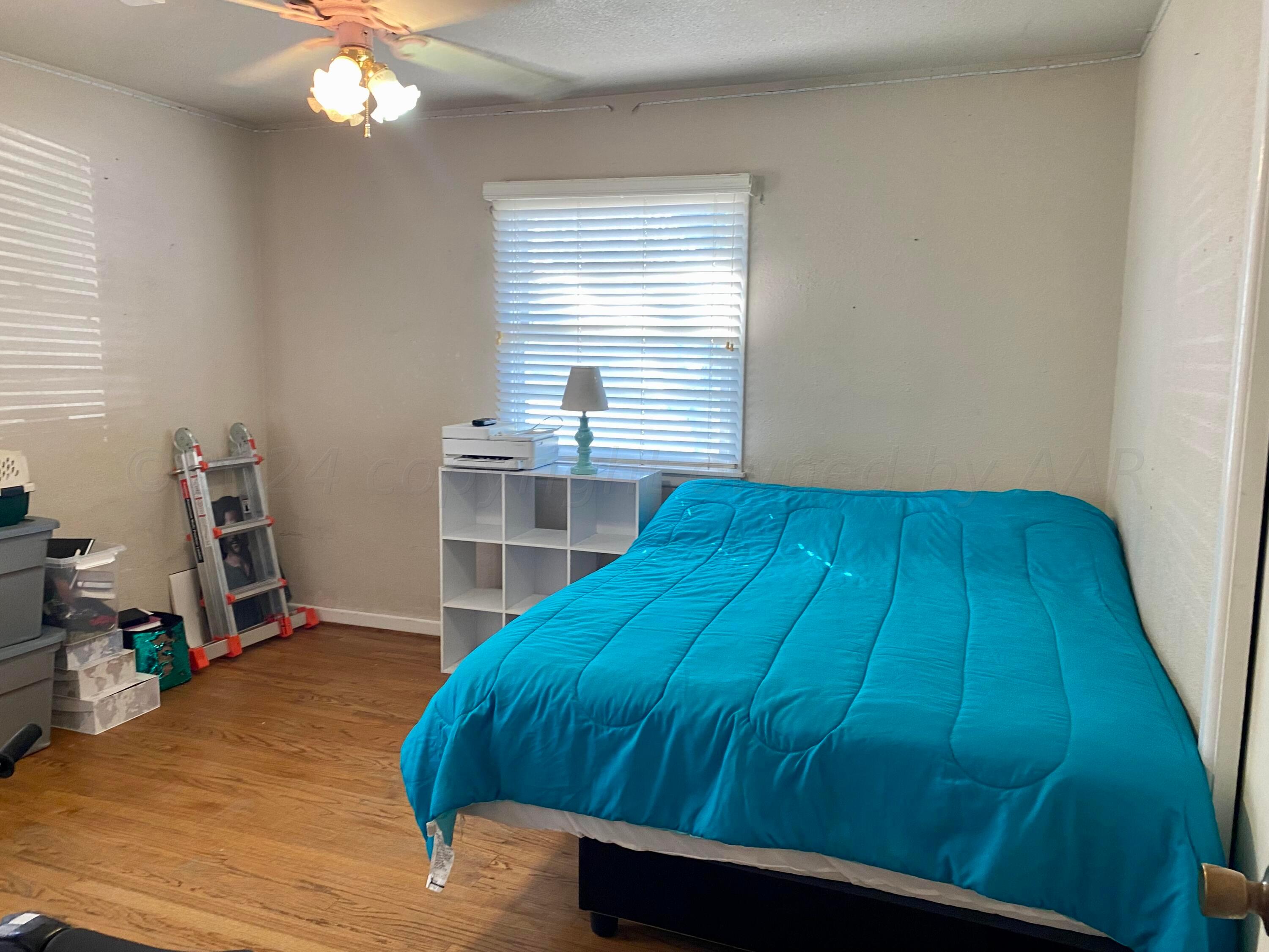 3309 Paramount Boulevard Amarillo, TX 79109 - Photo 9 of 26 a bedroom with a bed and a chandelier