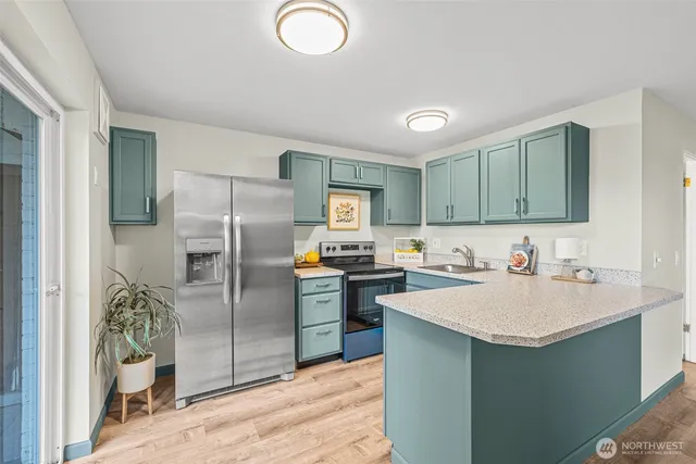 a kitchen with a sink a refrigerator and a stove