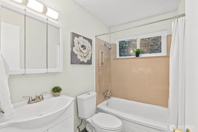 a bathroom with a toilet a sink and bathtub