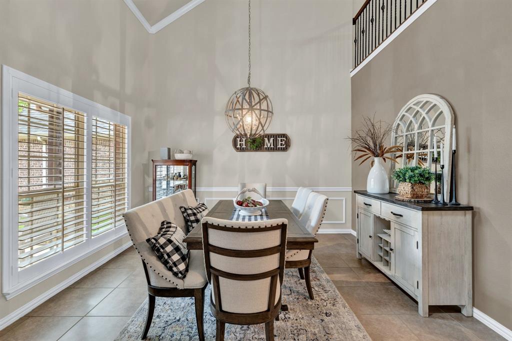 1701 Meadow Ranch Road McKinney, TX 75071 - Photo 5 of 40 a dining room with furniture a window and a chandelier