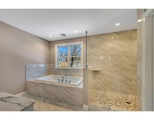 60 Bridge Street Needham, MA 02494 - Photo 23 of 28 a bathroom with a sink a mirror and a shower