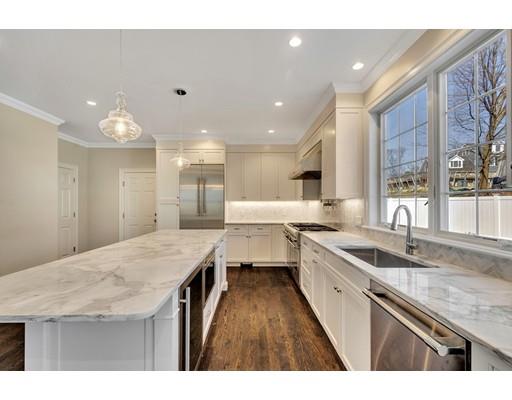 60 Bridge Street Needham, MA 02494 - Photo 10 of 28 a kitchen with a sink a counter top space and stainless steel appliances