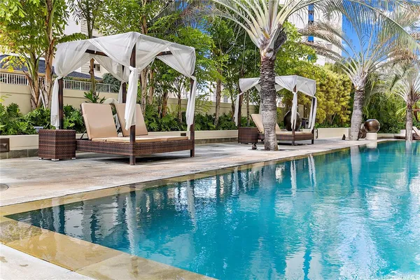 a view of pool with water fountain in front of it
