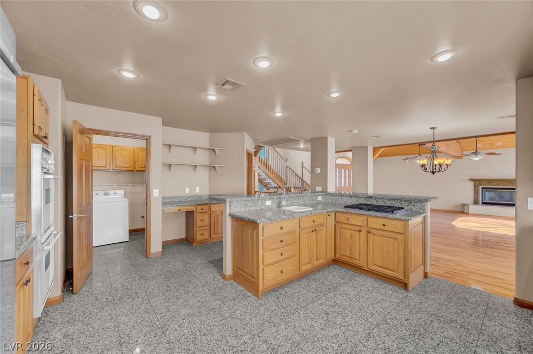 640 North Racetrack Road Henderson, NV 89015 - Photo 26 of 65 A well-appointed kitchen features ample counter space, custom cabinetry, and seamless flow into adjacent living areas.
