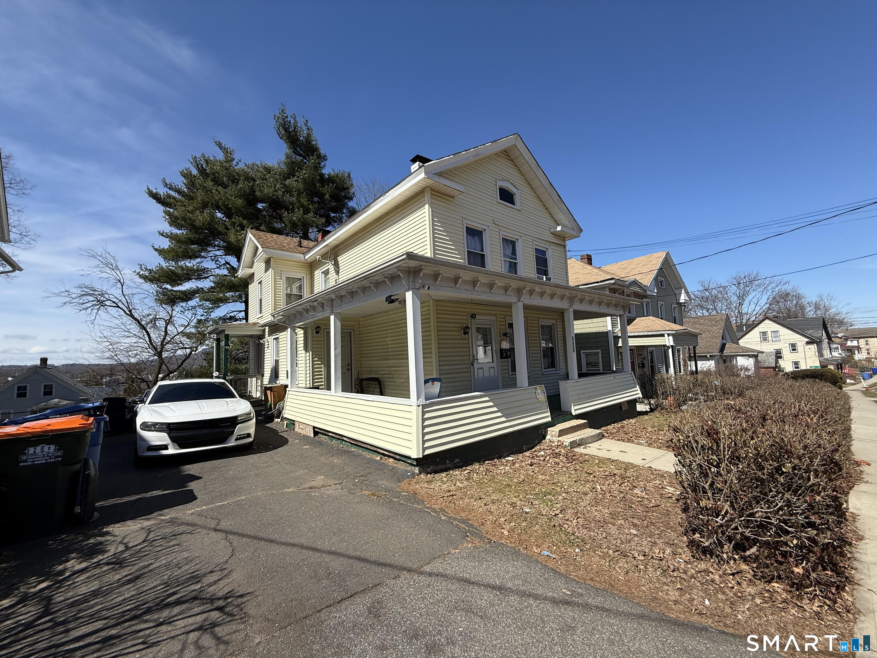 128 Hobart Street Meriden, CT 06450 - Photo 4 of 15 a view of a white house with a yard