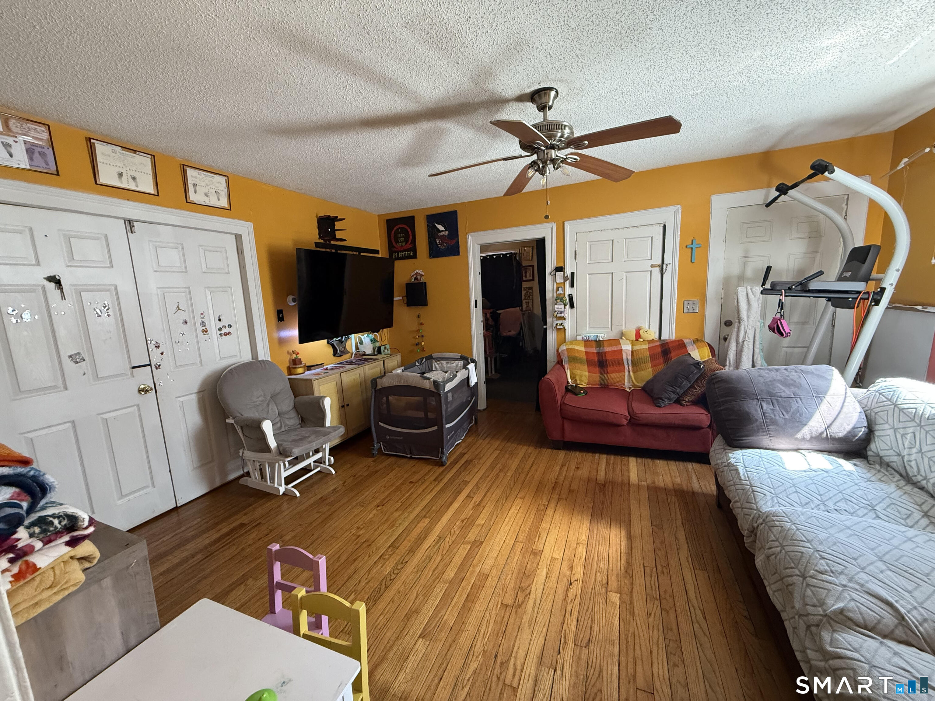 128 Hobart Street Meriden, CT 06450 - Photo 6 of 15 a living room with furniture a ceiling fan and a rug