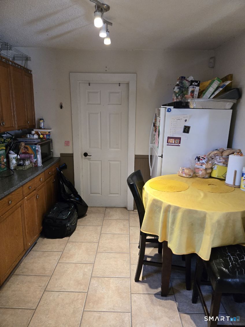 128 Hobart Street Meriden, CT 06450 - Photo 8 of 15 a bed room with a bed and a chair