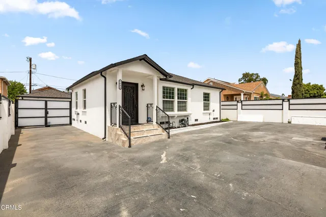 a view of a house with large windows and furniture