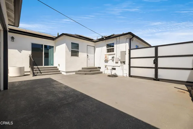 a view of a house with backyard and parking