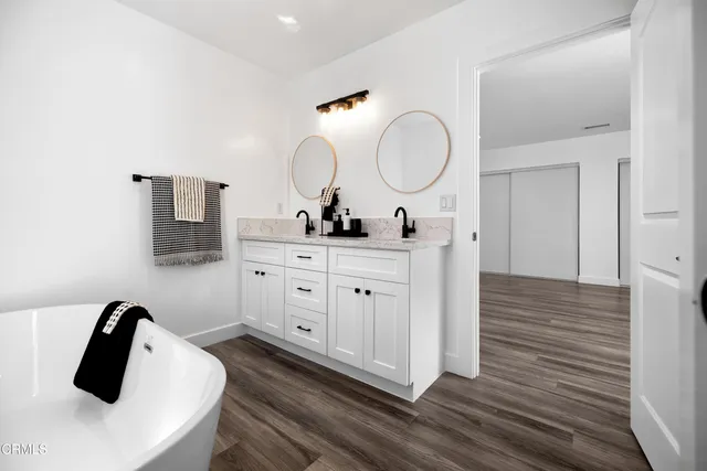 a bathroom with a double vanity sink and a mirror