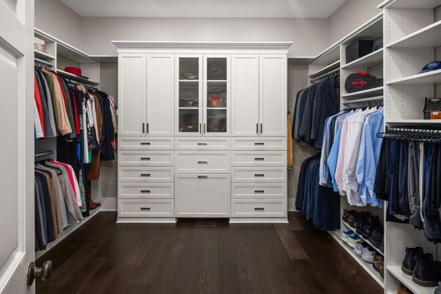 a room with gym equipment and wooden floor
