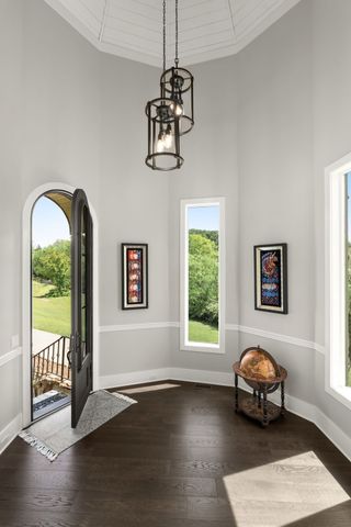 a living room with furniture and large windows