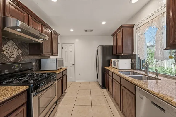 a bathroom with a granite countertop sink toilet and mirror