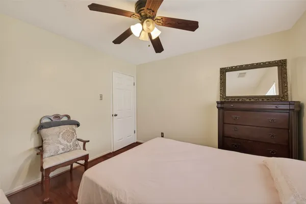 a bedroom with a bed and a chair