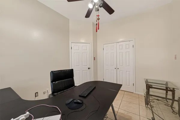 a bedroom with a bed and two window
