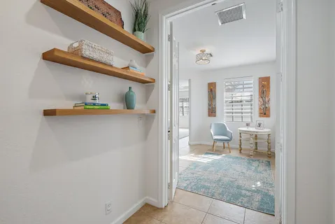 a bedroom with a bed and a flat tv screen on the dresser