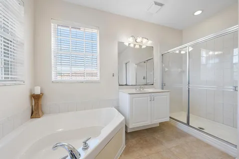 a bathroom with a sink a toilet and a large mirror