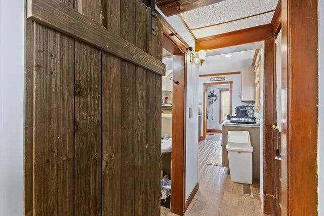 a bathroom with a sink a shelf and books