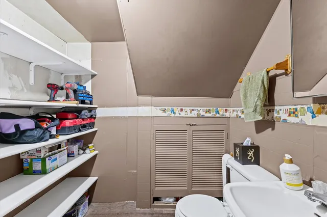 a bathroom with a sink a toilet and a mirror