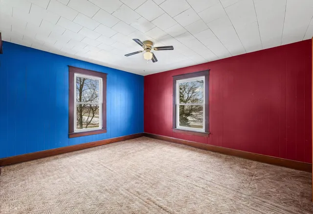 a view of a livingroom with a ceiling fan and window