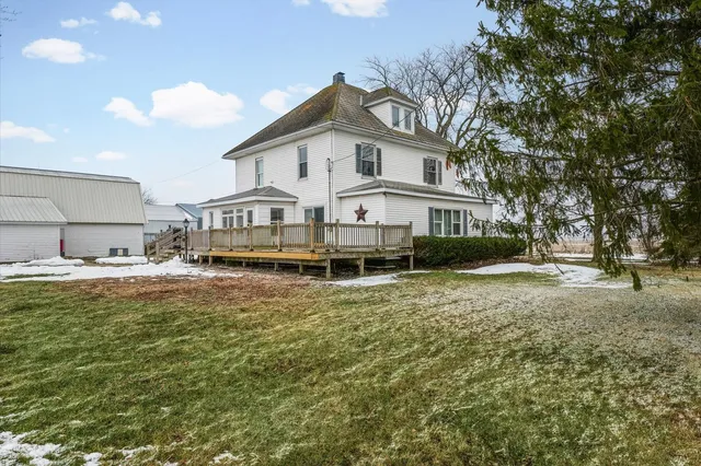 a view of a house with swimming pool and sitting area