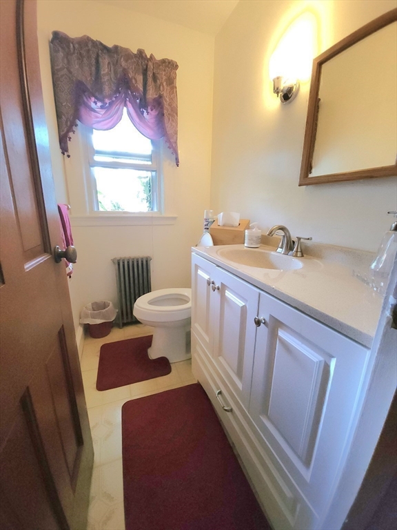 96 Brook Road Milton, MA 02186 - Photo 11 of 34 a bathroom with a toilet sink and mirror
