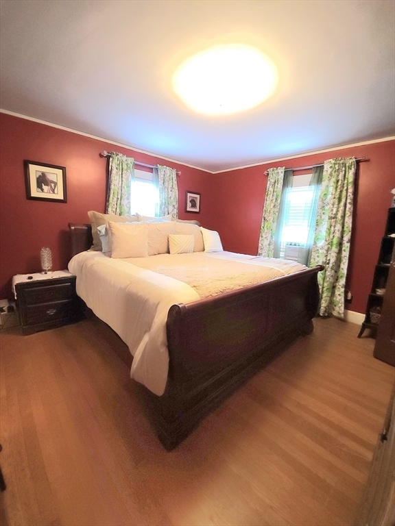 96 Brook Road Milton, MA 02186 - Photo 23 of 34 a bedroom with a bed and wooden floor
