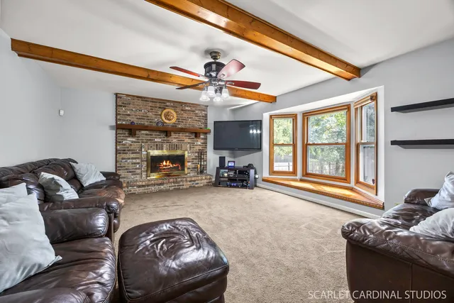 a living room with furniture and a fireplace