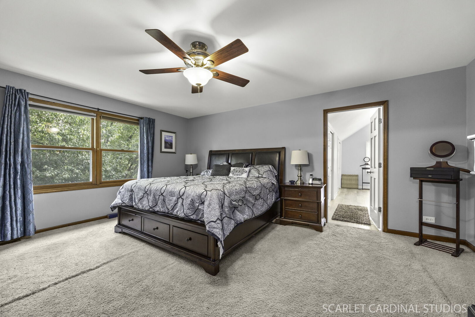 912 Sanctuary Lane Naperville, IL 60540 - Photo 15 of 31 a spacious bedroom with a large bed and a chandelier fan