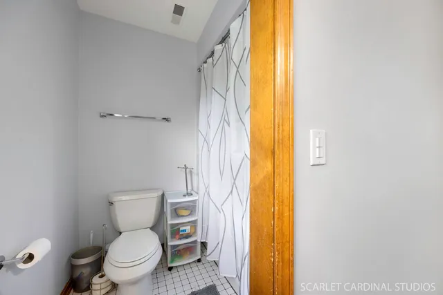 a white toilet sitting next to a bathroom