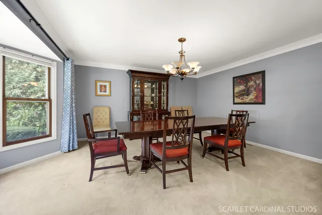 a dining room with furniture and chandelier