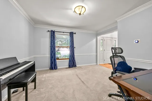 a view of a workspace with furniture and a window
