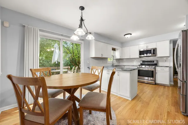 a view of a dining room with furniture large window and wooden floor