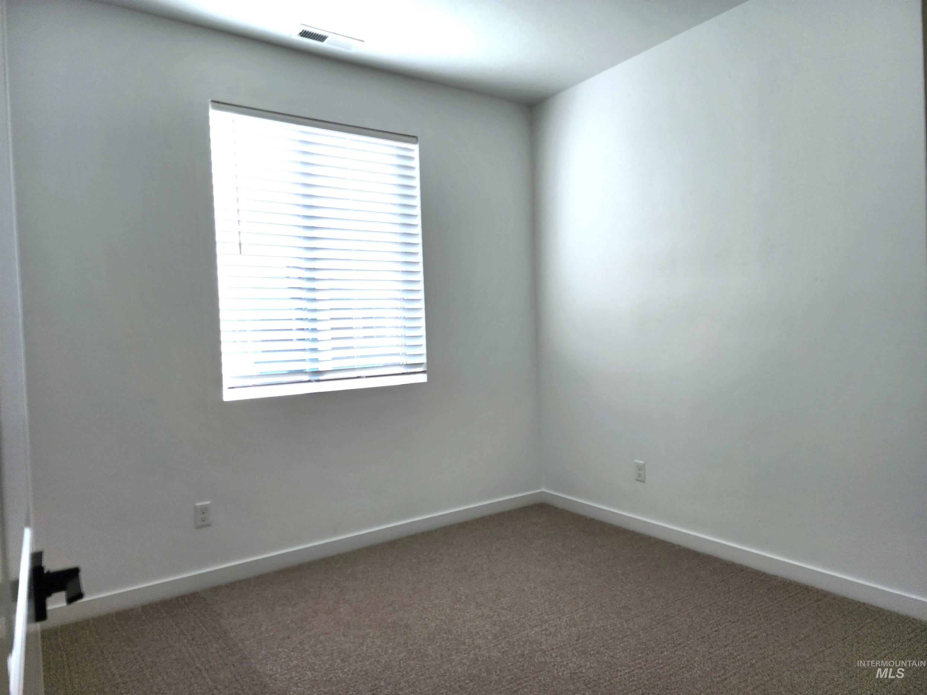 12267 West Endsley Street Star, ID 83669 - Photo 12 of 18 Carpeted spare room featuring baseboards