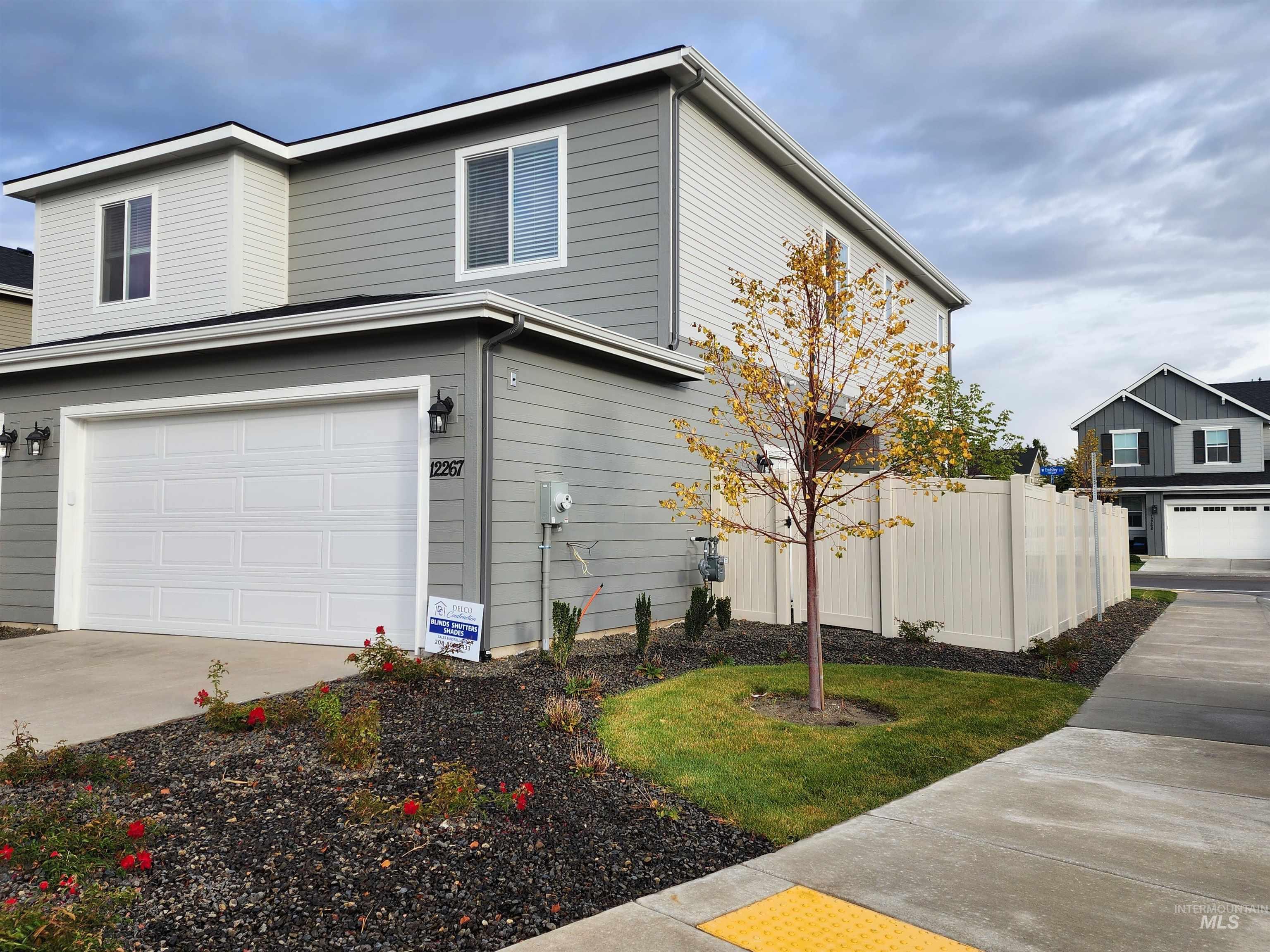 12267 West Endsley Street Star, ID 83669 - Photo 17 of 18 View of side of home with an attached garage and concrete driveway