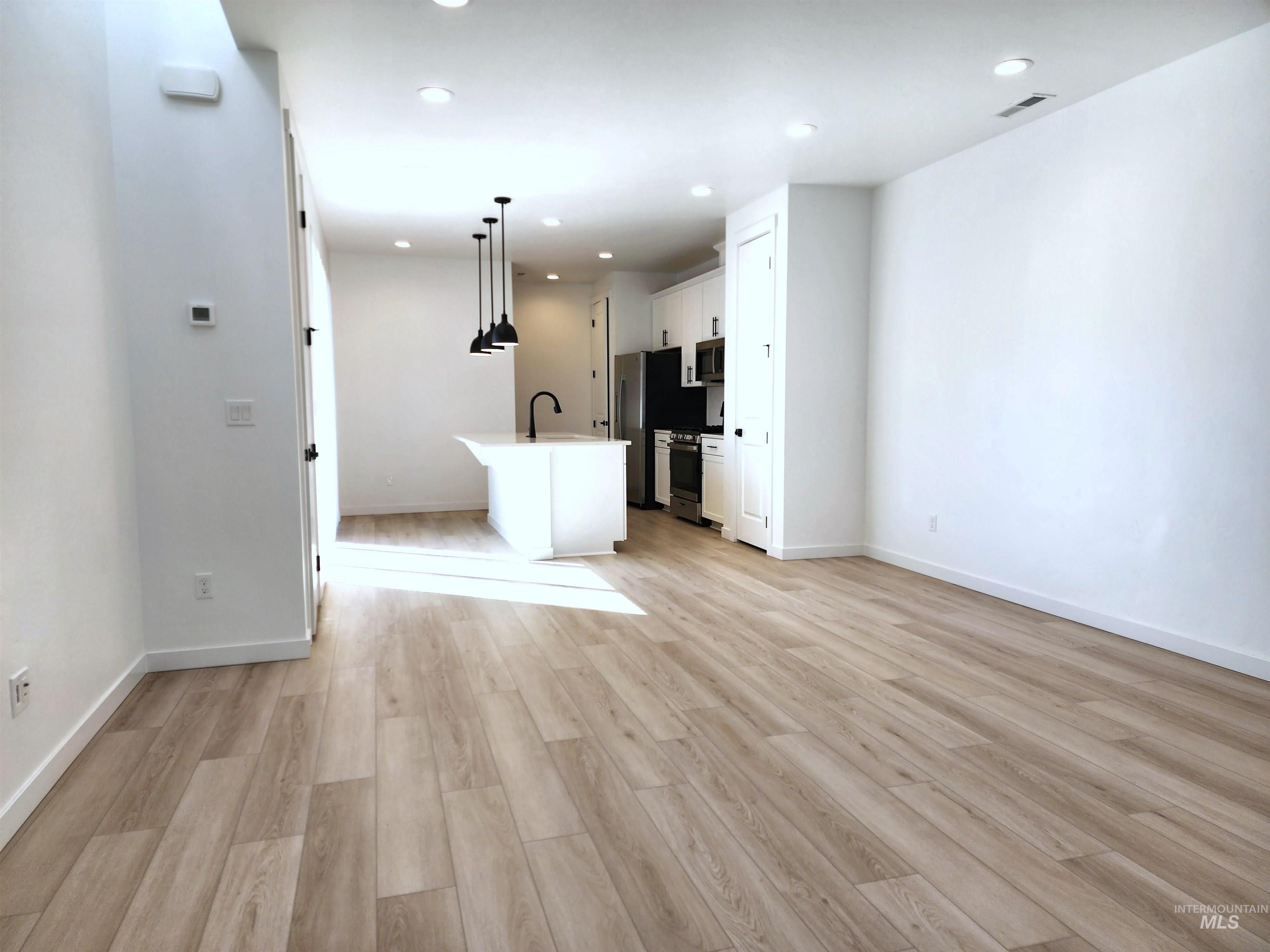12267 West Endsley Street Star, ID 83669 - Photo 2 of 18 Unfurnished living room with light wood finished floors and recessed lighting