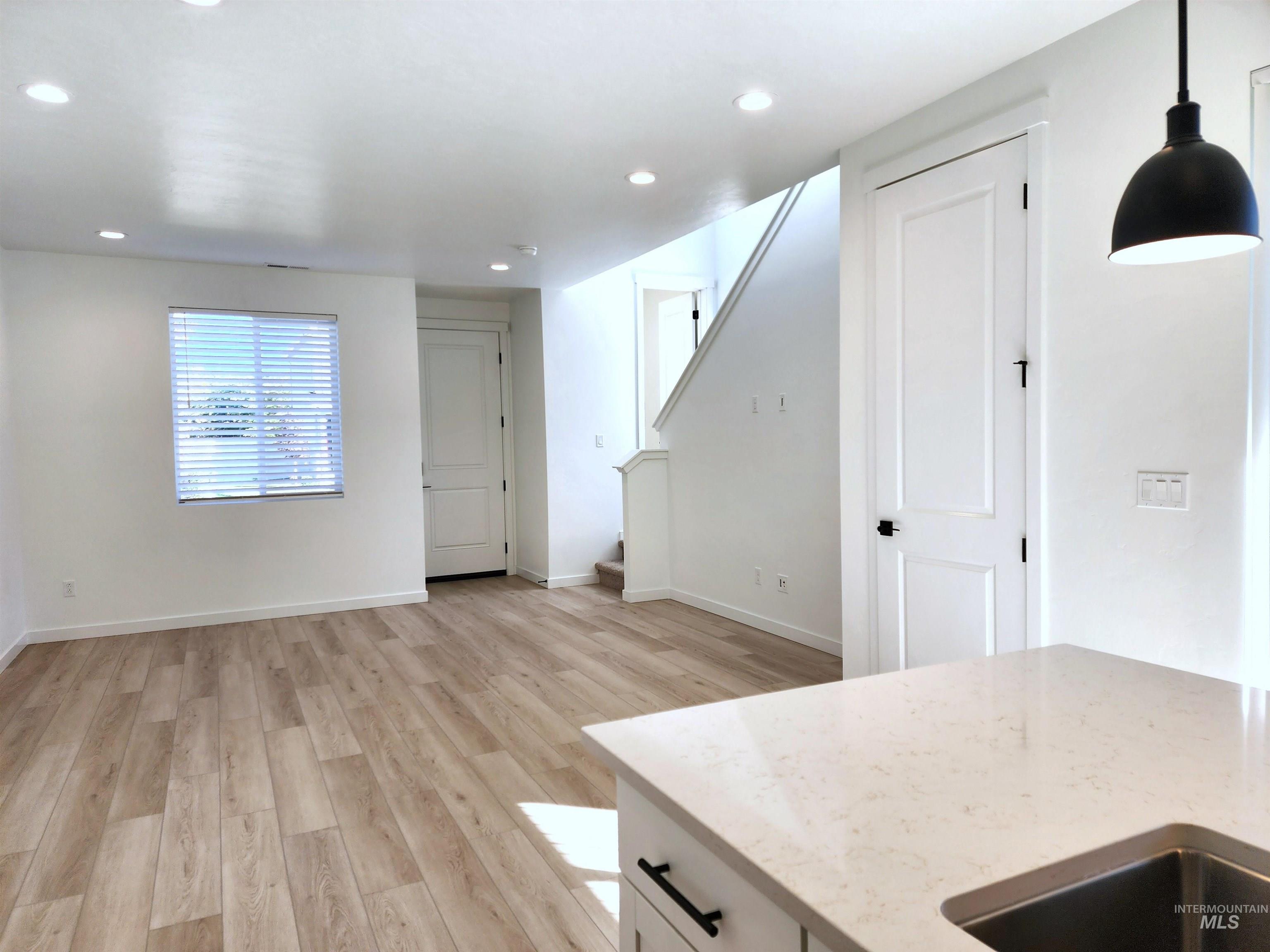 12267 West Endsley Street Star, ID 83669 - Photo 5 of 18 Unfurnished living room with light wood finished floors, stairs, and recessed lighting